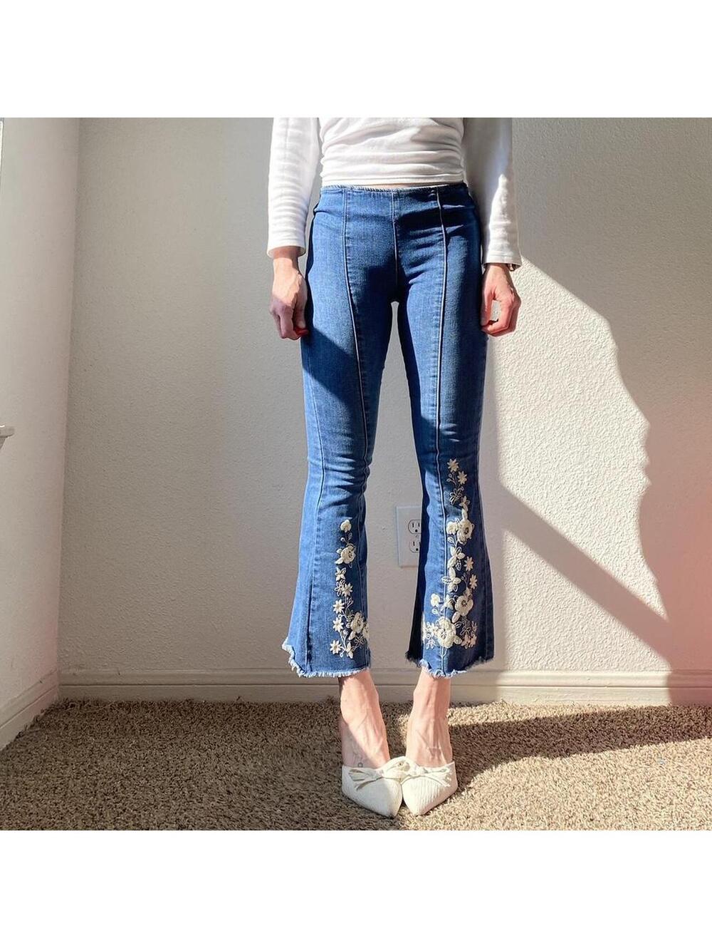 Low rise flare denim blue jeans with embroidered white lace floral detail